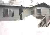 Shoveling snow off of the roof at Elk River